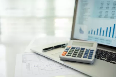 calculator, account statement and business report with financial budget portfolio show on screen laptop computer. accounting business concept.